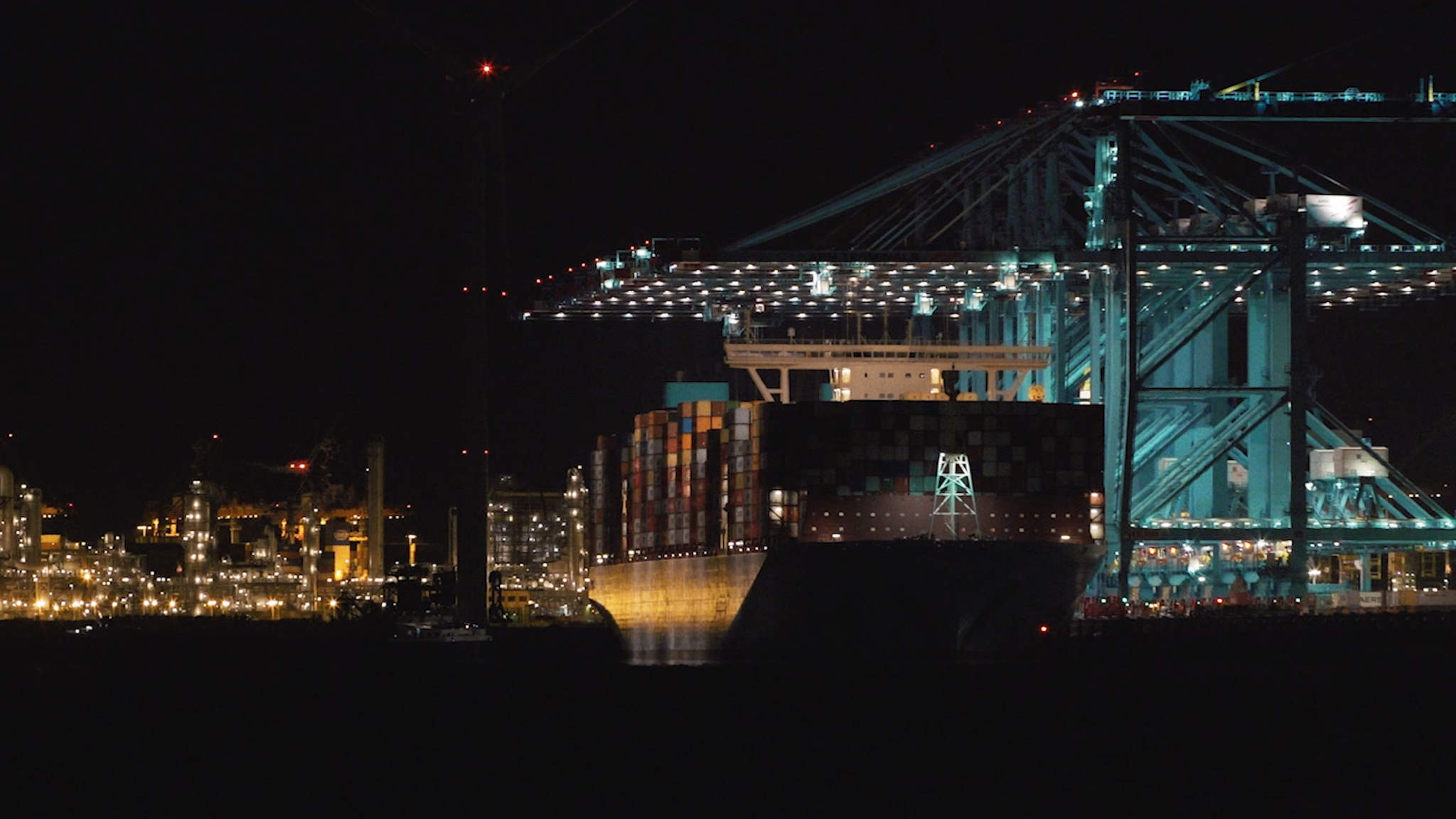 Cargo ship in the port of Rotterdam at nighttime.