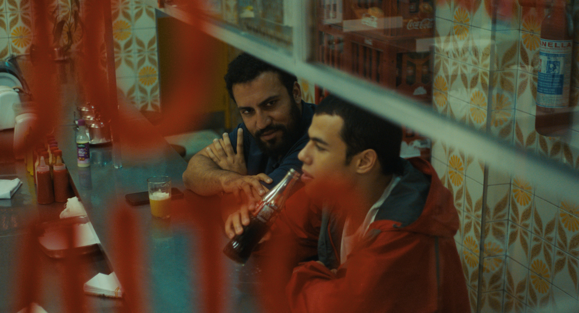 Two characters enjoying a cola in a bar in Brazil